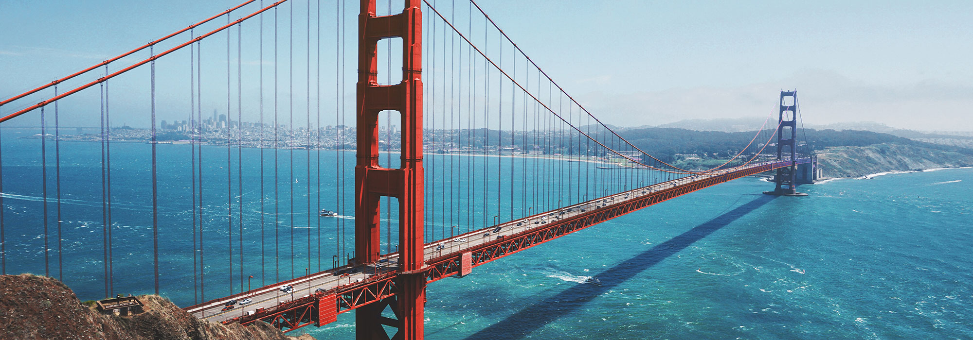 The Golden Gate Bridge and San Francisco California skyline seen from Golden Gate View Point on a sunny day; California Law Firm Marketing services concept image