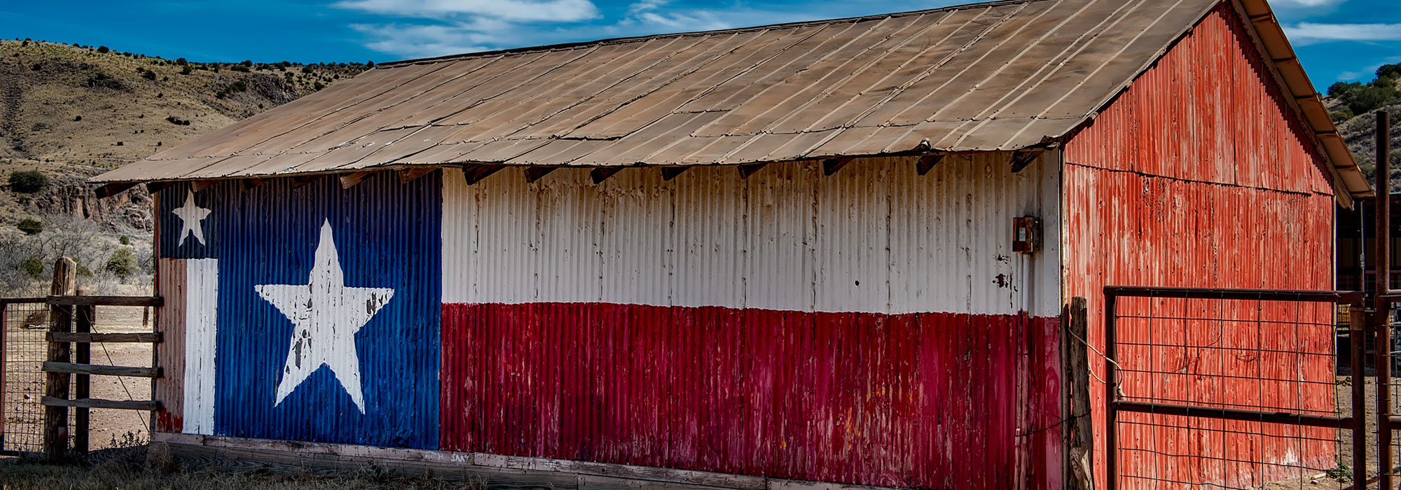Texan barn with Texas Flag painted on side; Texas Law Firm Marketing concept image