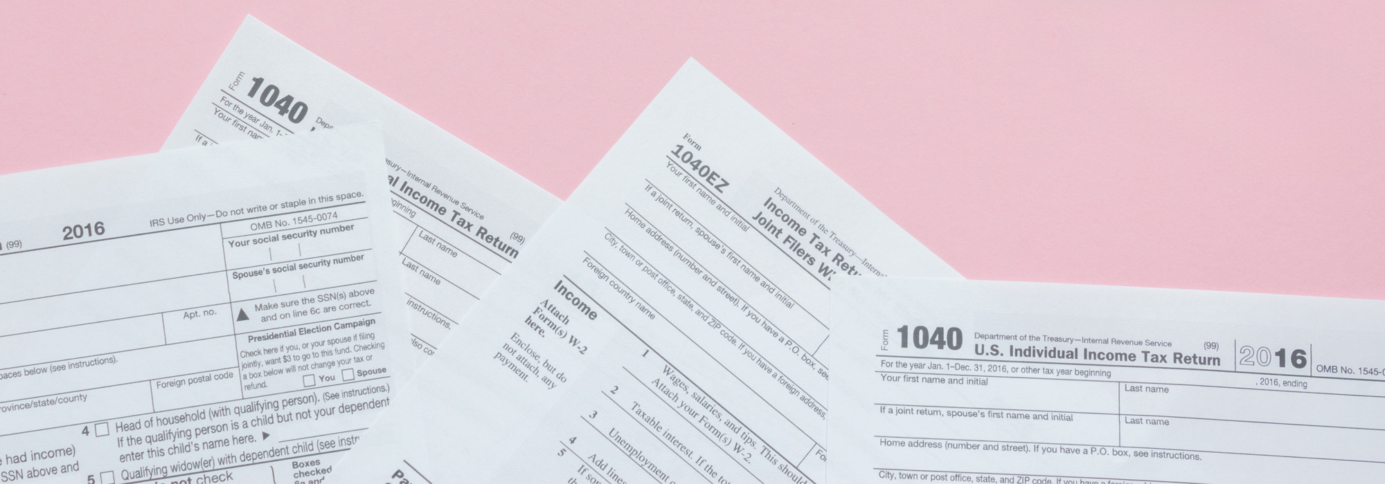 US 1040 Tax forms on pink minimalist background