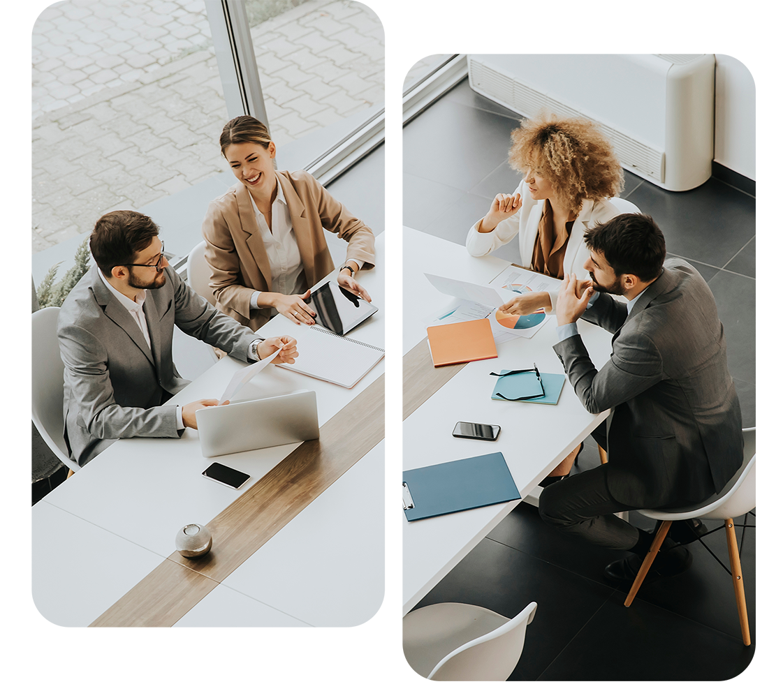 Four business professionals are sitting around a modern white table with laptops, notepads, and smartphones. Engaged in a discussion on law firm marketing services in a well-lit office with large windows, the atmosphere appears collaborative and focused.