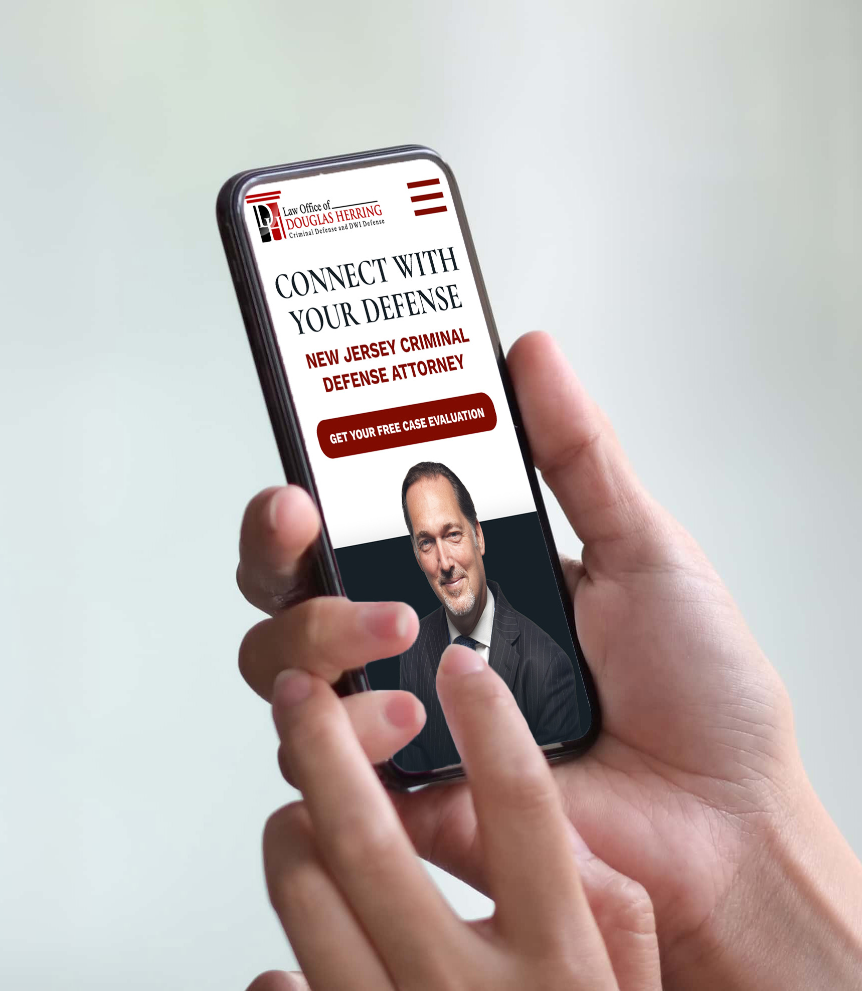 A person holds a smartphone displaying a law firm's website featuring a male attorney's photo and text offering a New Jersey criminal defense attorney and a free case evaluation.