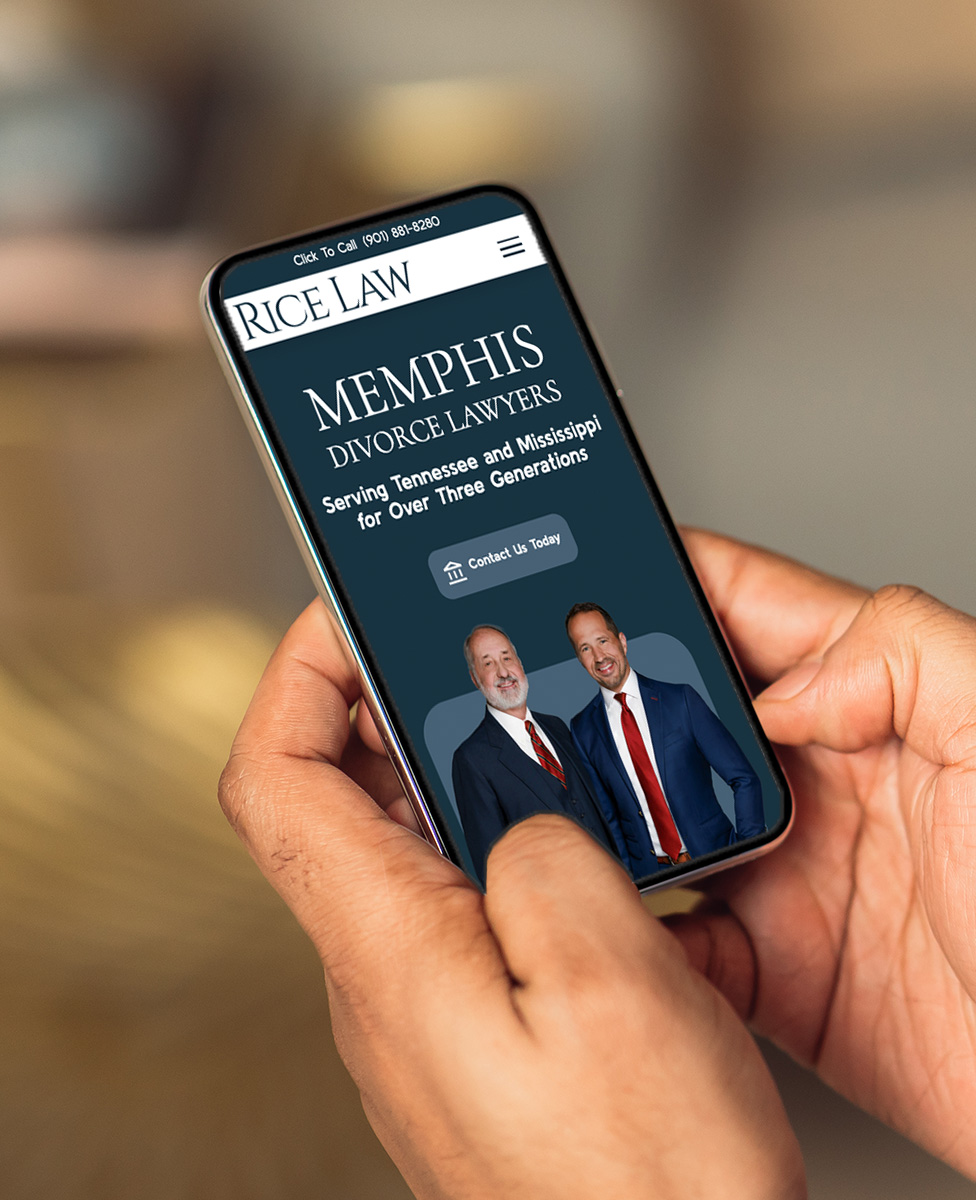 A person holds a smartphone displaying the Rice Law website, featuring two men in suits promoting Memphis divorce lawyers who serve Tennessee and Mississippi.