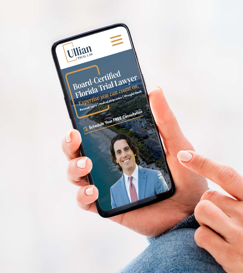 A person holds a smartphone displaying a law firm's website featuring a smiling man in a suit, a coastal background, and text about a board-certified Florida trial lawyer offering free consultations.
